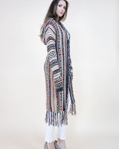 women's hooded tribal knit sweater Multicolor Fringe Winter Outerwear, Casual Multicolor Fringe Outerwear, Casual Multicolor Fringed Outerwear, Long Fringed Outerwear For Winter, Long Winter Outerwear With Fringe, Long Fringe Outerwear For Winter, Long Winter Outerwear With Tassels, Bohemian Multicolor Outerwear With Tassels, Bohemian Long Multicolor Sweater Coat