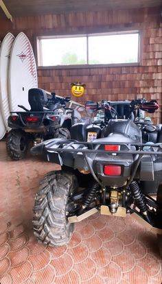 several atvs are parked in a garage