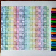 some colored crayons are sitting on top of a piece of paper that has been drawn