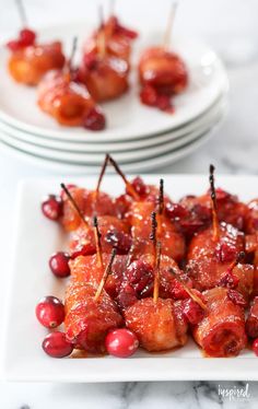 small appetizers with cranberry sauce and toothpicks on white plates