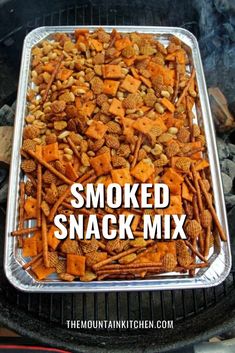 the words smoked snack mix in front of an image of some food on a grill