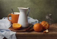 an orange and pitcher on a wooden tray