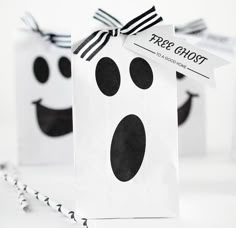 two white bags with black polka dots and a ghost face tied to the top one