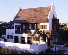 a white house with a brown roof and windows