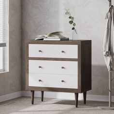 a white and brown chest of drawers in a room