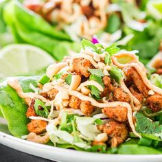 a white plate topped with lettuce and meat