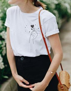 This super cute heart snap finger tee has a very soft, loose fit! So comfy and cool for a casual outfit. Tie on the side for a cropped look and style with high waist denim bottoms. ------------------------------------------------------------------------------------------------------------------------------------------------- * 100% ring-spun cotton * 4.5 oz/y² (153 g/m²) * Pre-shrunk * Shoulder-to-shoulder taping * Quarter-turned to avoid crease down the center ---------------------------------- Casual Heart Print T-shirt With Relaxed Fit, Casual Relaxed Fit T-shirt With Heart Print, Trendy Relaxed Fit T-shirt With Heart Print, Casual Heart Print T-shirt For Summer, Trendy T-shirt With Heart Graphic For Everyday, Trendy Heart Print T-shirt For Spring, Heart Graphic Tee For Everyday, Everyday Graphic Tee With Heart Graphic, Heart Graphic Tee For Everyday Wear