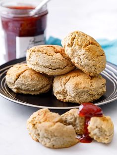 several biscuits on a plate with ketchup next to it