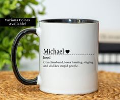 a black and white coffee mug with michael quote on the inside is sitting on a table next to a potted plant