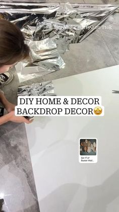 a woman is painting a white table with foil on it and the words diy home & decor back drop decor