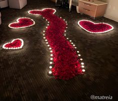 the floor is decorated with flowers and hearts for valentine's day decorations, along with candles