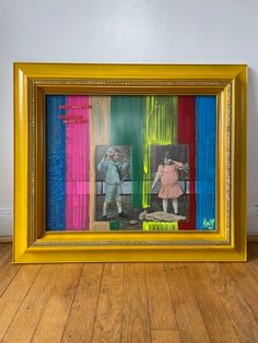 an image of two children standing next to each other in front of a painting on the wall