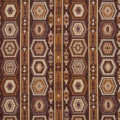 a brown and white rug with many different designs on the side, including hexagonal shapes