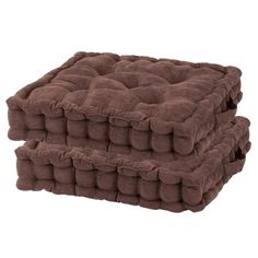 two brown cushions stacked on top of each other