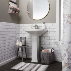 a bathroom with a sink, mirror and rug