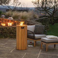 a fire pit sitting on top of a patio next to a chair