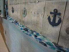 an anchor is on the side of a wall with blue and white fabric around it