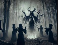 several people dressed as witches standing around a campfire in the woods with their heads turned to look like an antelope