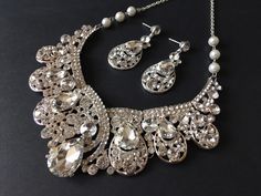 "This necklace is soooo romantic and beautiful which you (and me) can deny of it!! Very vintage Victorian sparkle pendant and we have embellished with pearls chains to make it look more feminine!! We have also added an extra long cable chain finished with a sparkle pendant at end for you to adjust the length. Size: necklace around 14\" long and 2\" width Color: silver with clear rhinestone crystals and pearls Item ship out with tracking number to you (around 10 to 14 business days for delivery). Pearls Chains, Victorian Style Wedding, Bride Jewelry Set, Victorian Necklace, Bridal Choker, Crystal Headpiece, Crystal Jewelry Sets, Necklace Bridal, Dangle Necklaces