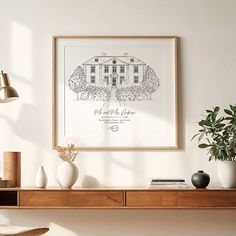 an art print hangs on the wall above a wooden shelf with vases and plants