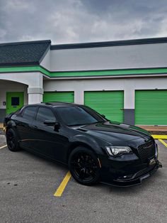 a black car parked in front of a building