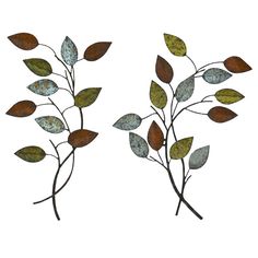 two metal leaves are shown against a white background, one is green and the other is brown