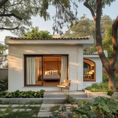 a small white house with an open patio