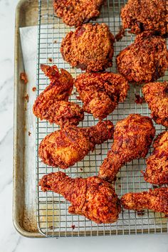 some fried food is on a cooling rack and ready to be cooked in the oven