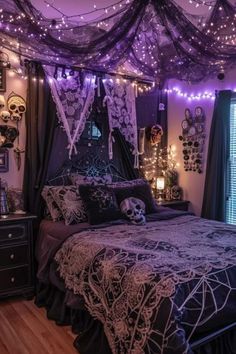 a bedroom decorated in purple and black with string lights on the ceiling, bedding and curtains