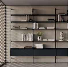 a book shelf with many books on it in a room that has checkered walls