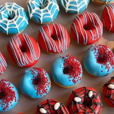 there are many decorated donuts on the table together and one is red, white, and blue