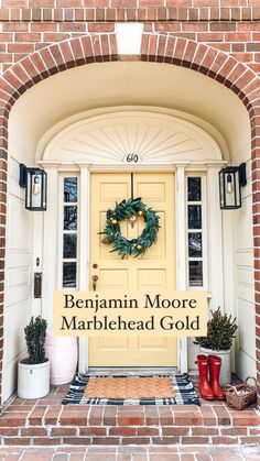 a yellow front door with the words, benjamin moore marblehead gold on it's side