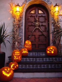 pumpkins carved to look like jack - o'- lantern faces on the steps