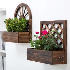 two wooden window boxes with flowers in them