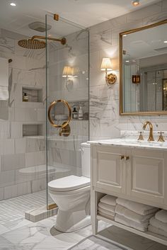 a white bathroom with gold accents and marble walls