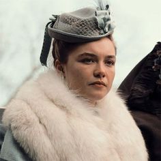 a woman wearing a fur coat and hat