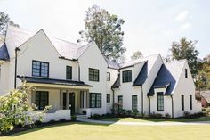 a large white house with black trim and windows