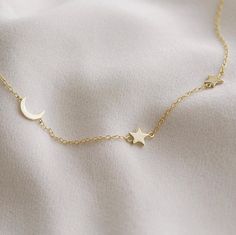 A tiny crescent moon hangs off center along a delicate chain that's adorned with two mini stars. It's the perfect, barely-there piece with a major celestial vibe. Available in gold, rose gold and silver.DETAILS: 14kt gold vermeil or sterling silver 16" long with 2" extender Moon And Star Necklace, Mini Stars, Deer Jewelry, Delicate Gold Necklace, Star Necklace Silver, Star Necklace Gold, Bar Necklace Personalized, Rose Gold And Silver, Gold Coin Necklace