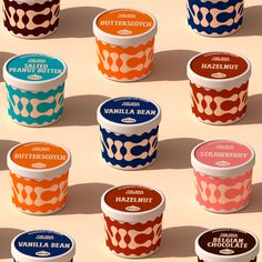 several ice creams in different flavors on a tan surface with shadows from the top