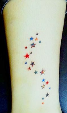 a woman's foot with stars on it and the word love written in red, white and blue ink