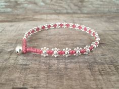 "Very cute women bracelet or anklet made with 2.4mm and 4mm silver plated beads look like a flower woven together with pink waxed cord and silver bell for closure. *Size: Choose your size or color of cord from the drop-down menu. **If you don't need a bell for closure, just take note to me in the message to seller *✈️ Shipping.. The item shipped by Registered Airmail Thailand Post within 3-5 working days after payment received. **If you will NOT be home to sign for the package, Please leave note Pink Beaded Bohemian Anklets, Adjustable Pink Anklet With Colorful Beads, Adjustable Pink Nickel-free Beaded Bracelets, Adjustable Pink Woven Bracelet, Red Flower-shaped Bohemian Beaded Bracelets, Beautiful Anklet, Silver Bells, Beaded Anklets, Chain Anklet