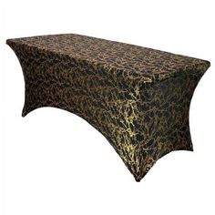 a black and gold table cloth with an animal print design on the top, sitting in front of a white background