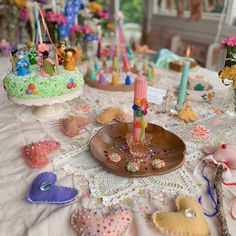 a table topped with lots of different types of cakes and candies on top of it