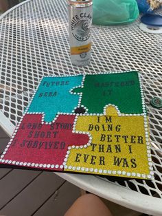 a piece of puzzle sitting on top of a table next to a can of soda