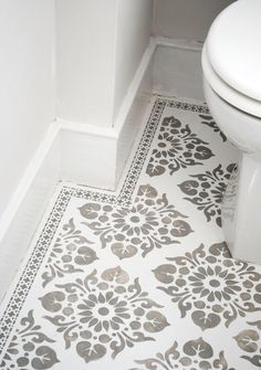 a white toilet sitting next to a bath tub in a bathroom