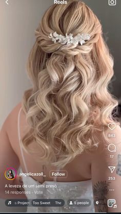 the back of a woman's head with long blonde hair and flowers in her hair