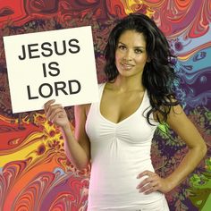 a woman holding a sign that says jesus is lord