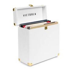 a white chest with gold handles holds records and folders in its storage compartment, which is open to reveal the word victory