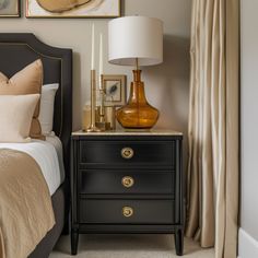 a bed room with a neatly made bed and two nightstands next to each other