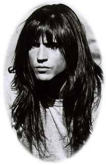 a black and white photo of a person with long hair